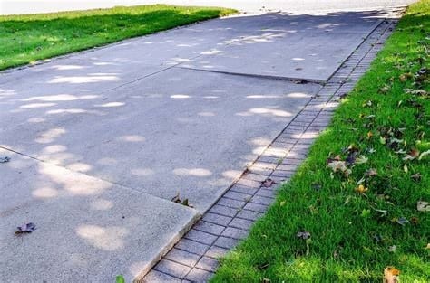 Cracked and sunken driveway before concrete leveling